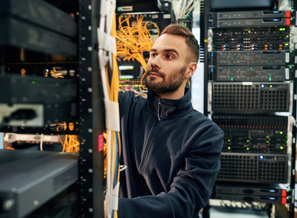 Black,Clothes.,Young,Man,Is,Working,With,Internet,Equipment,And